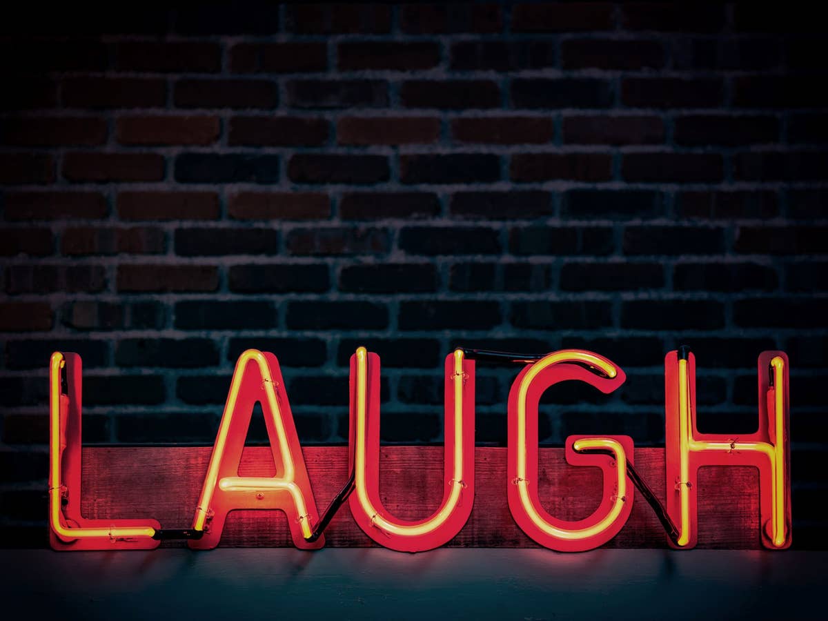 Das Wort Laugh in Neon Lichtern