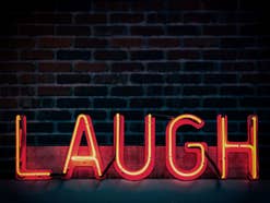Die-lustigsten-Comedy-Serien Das Wort Laugh in Neon Lichtern