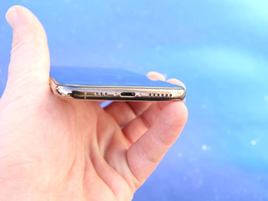 Das iPhone XS in der Hand mit Ansicht des unteren Rahmens