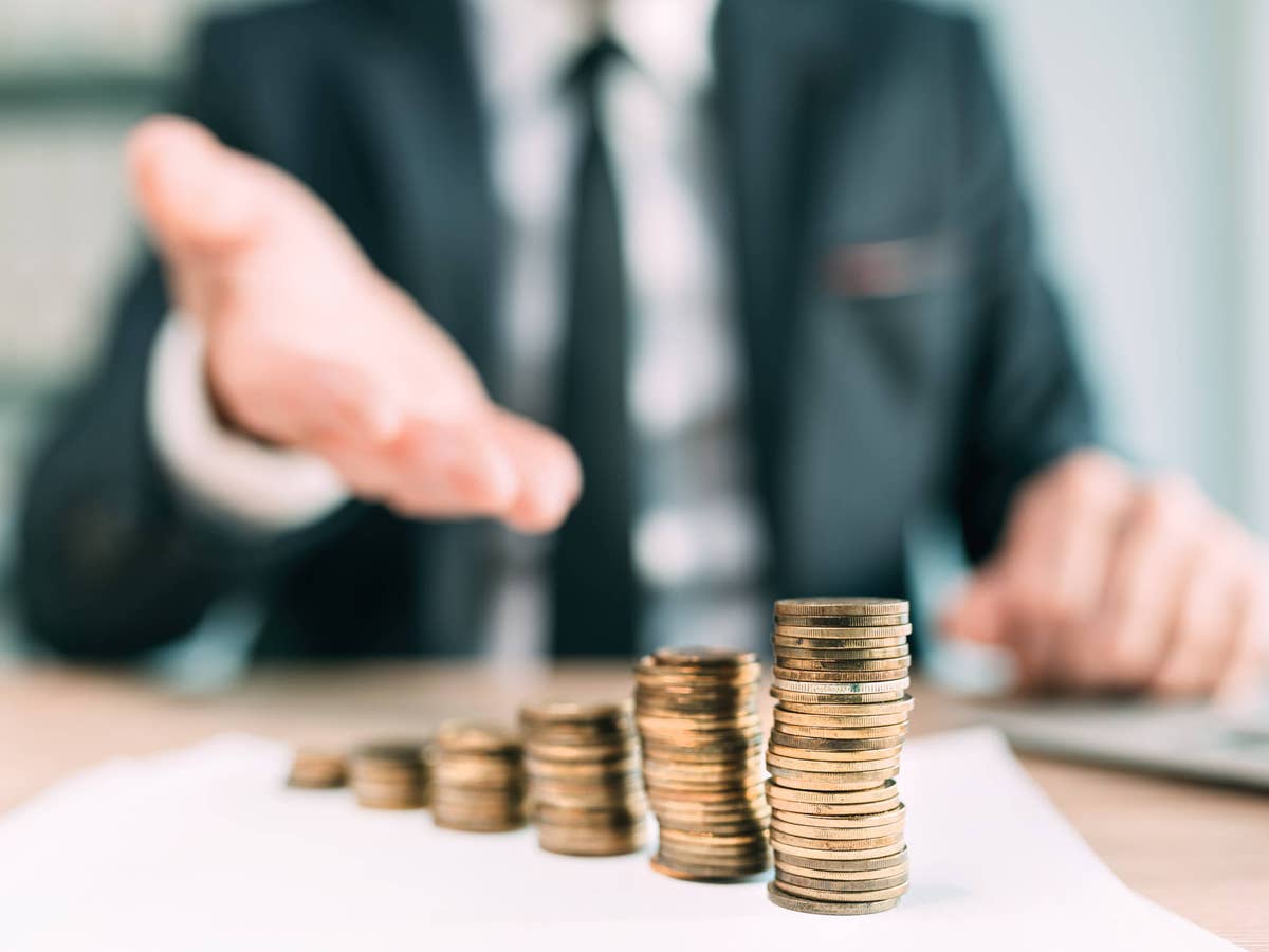Hand of a bank employee over money coins.