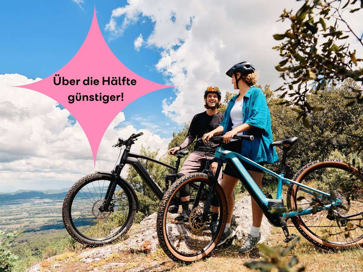 Zwei Personen stehen mit E-Bikes auf einem Weg