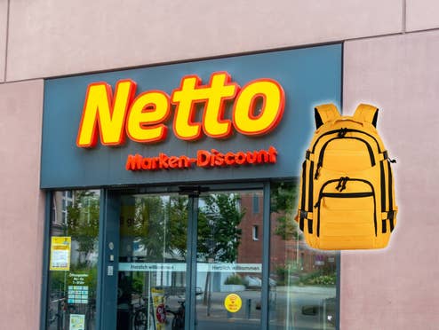 Eingang eines Netto-Geschäfts daneben ein Notfallrucksack