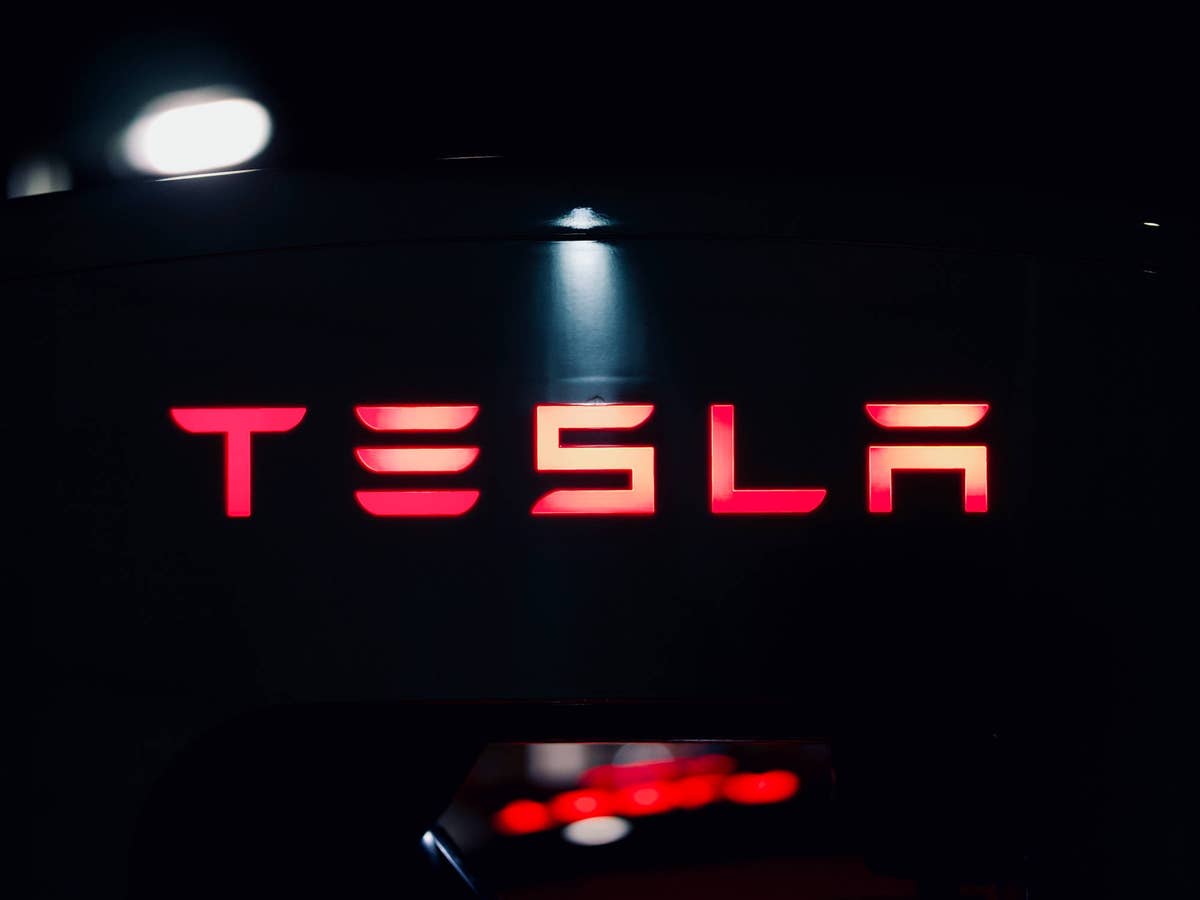 Tesla-Logo vor schwarzem Hintergrund.