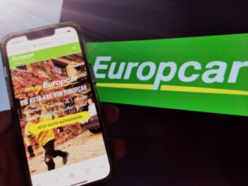 Europcar myEuropcar auf einem Smartphone vor einem Europcar-Logo.