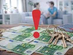 Ein Bund Schlüssel liegt auf 100-Euro-Scheinen