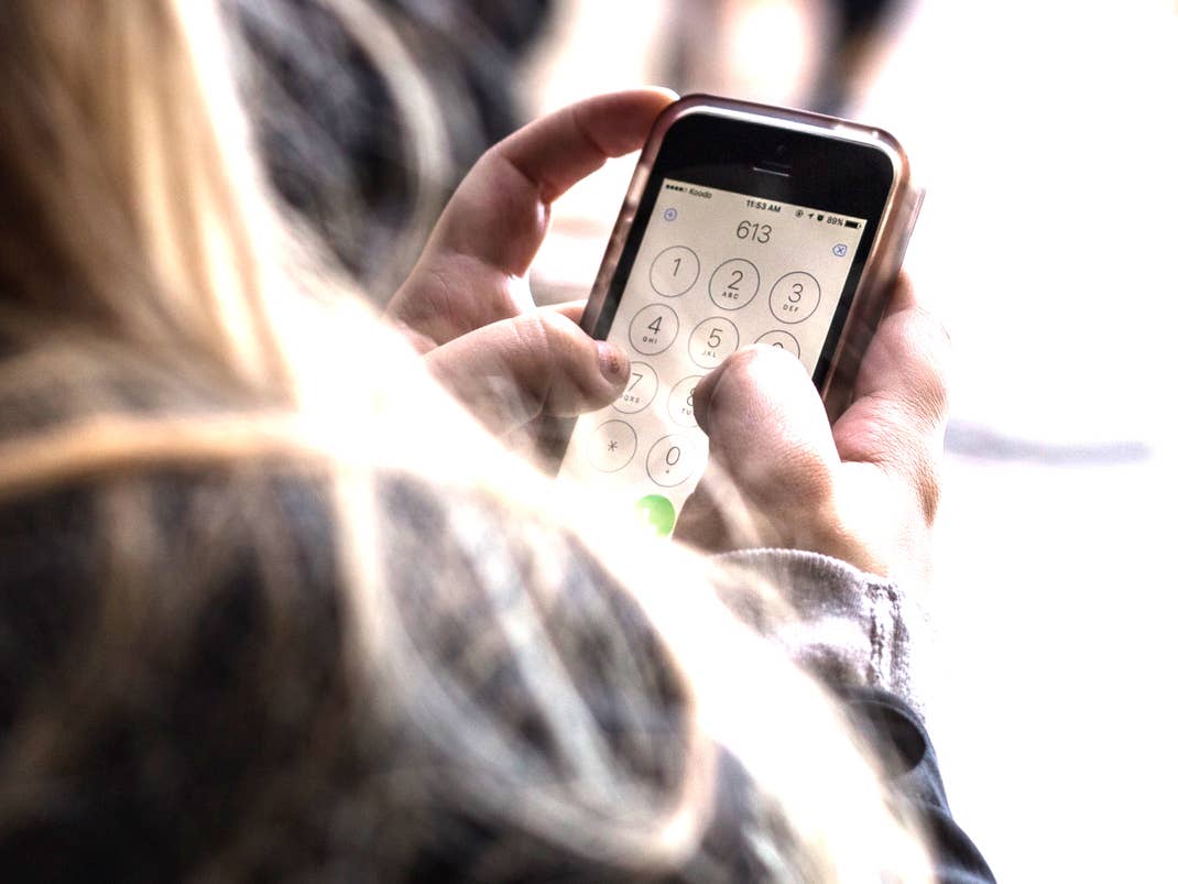 Operate the cell phone with the thumbs of both cell phones