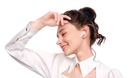 Huawei FreeBuds 4i im Ohr einer Frau.