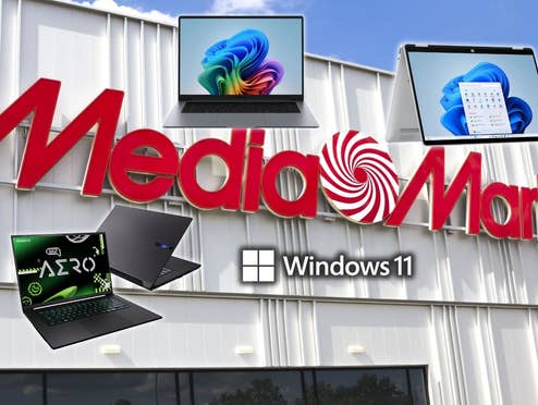 MediaMarkt-Store im Hintergrund, vorne Laptops von HP, Samsung und Gigabyte sowie das Windows 11 Logo