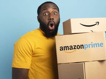 Mann hält Amazon-Pakete mit Amazon Prime Schriftzug