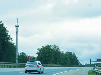 Ein Mobilfunk-Sendemast steht an einer Autobahn