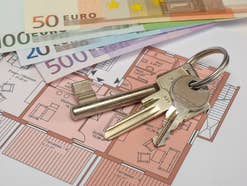 Schlüssel und Euroscheine die auf einem Grundriss liegen