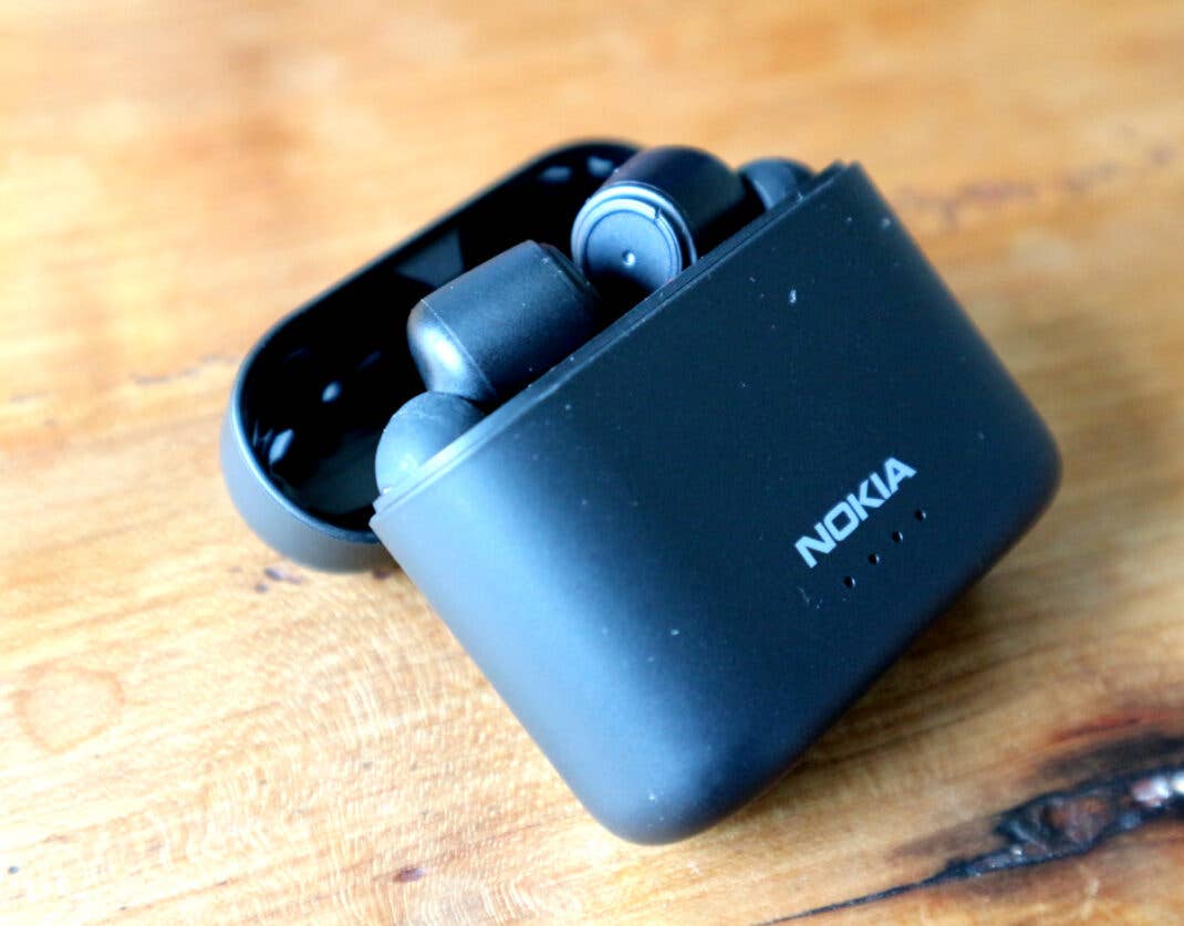 Die Nokia Noise Cancelling Earbuds einzeln auf einem Holztisch.