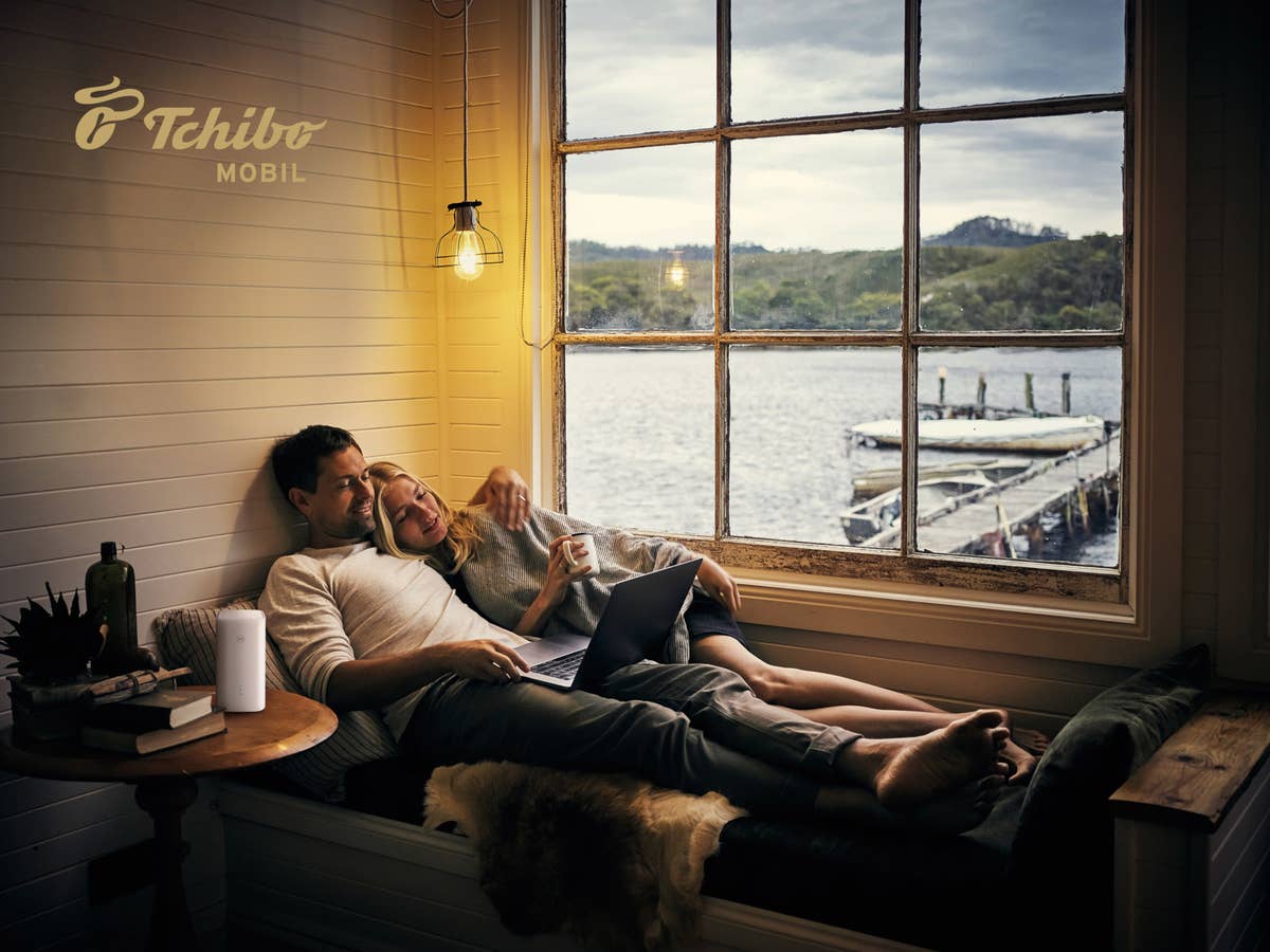 Mann und Frau in einem Ferienhaus mit dem Notebook.