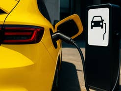 Gelbe E-Auto steht an einer Ladesäule.