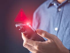 Smartphone mit Warnmeldung.