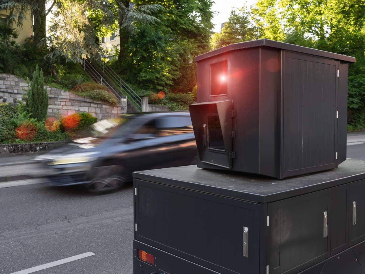 Eine Radarkamera am Straßenrand, im Hintergrund ein Auto
