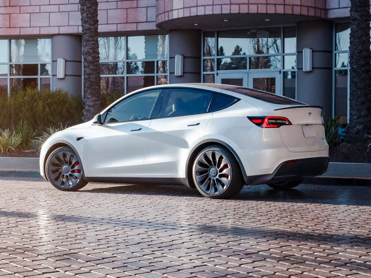 Tesla demontiert die Konkurrenz Tesla Model Y steht vor einem Haus.
