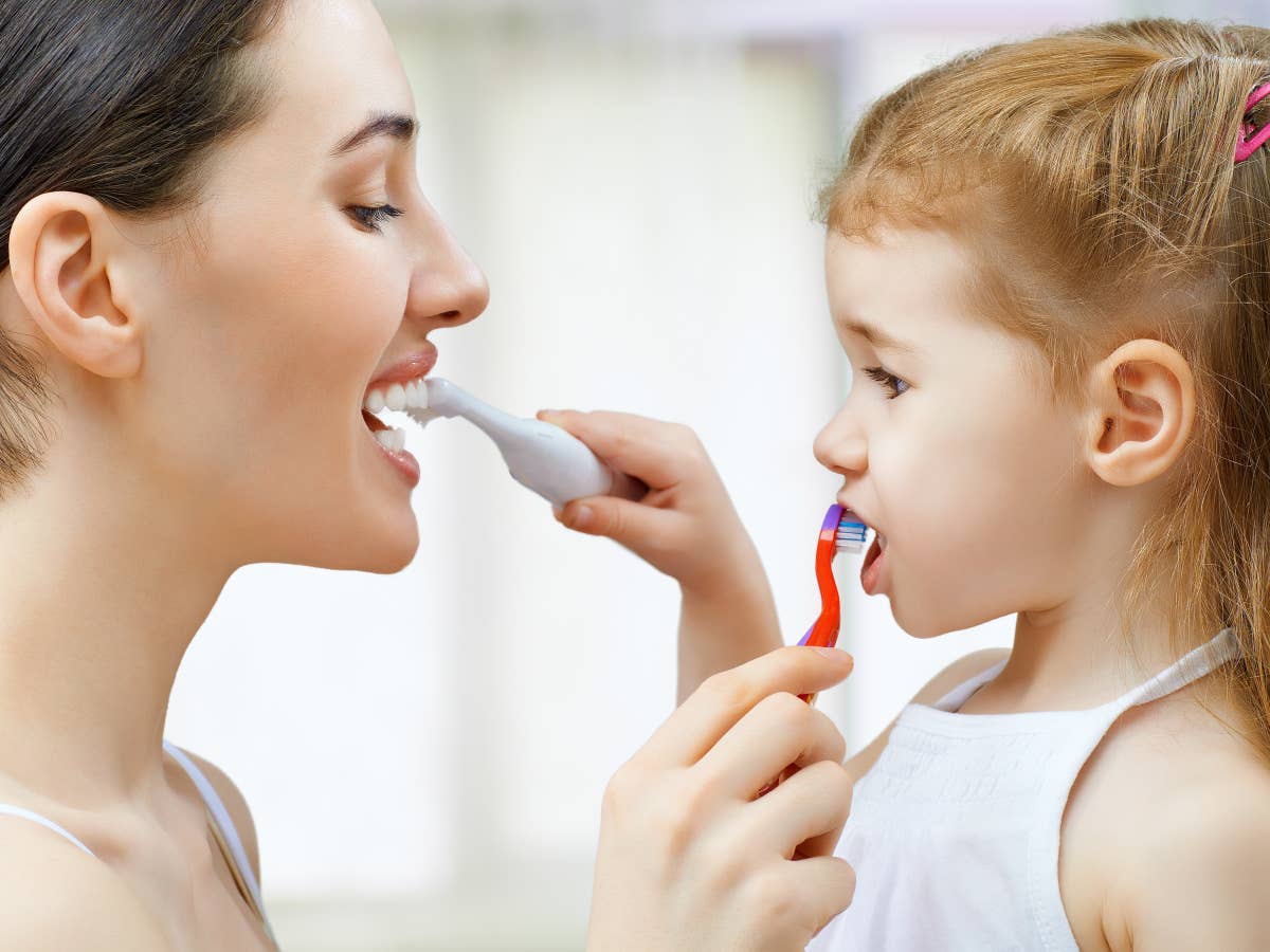 Mutter und Kind putzen Zähne